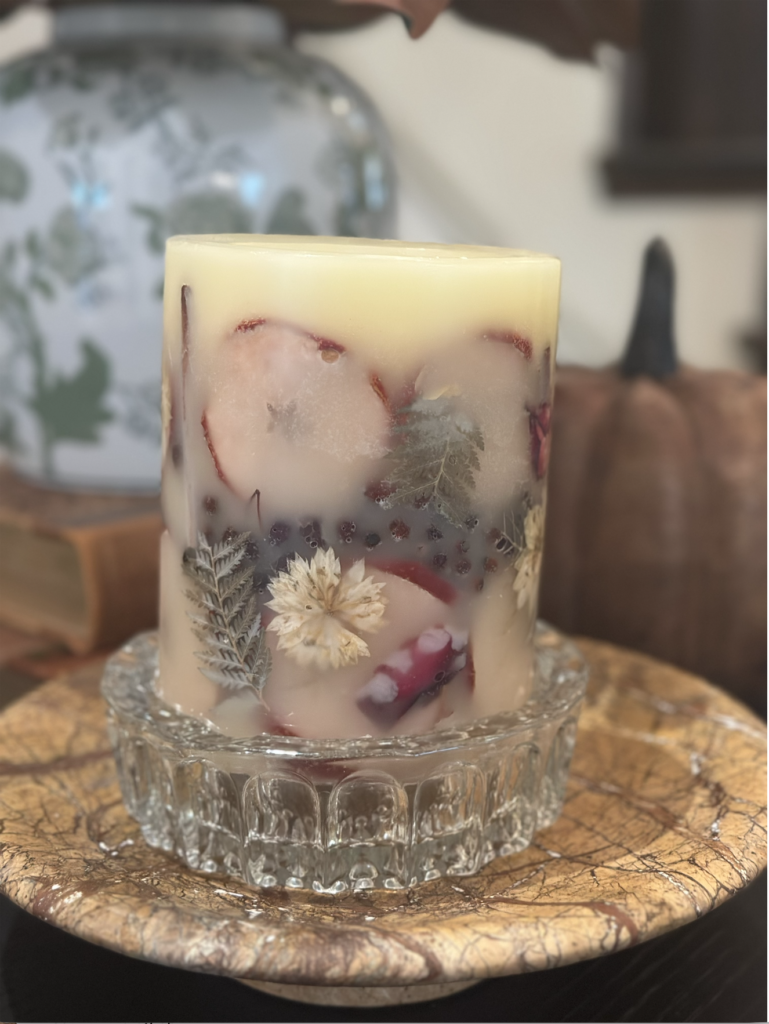 Rosey Rings spiced apple candle with pressed flowers, set in a vintage crystal ashtray